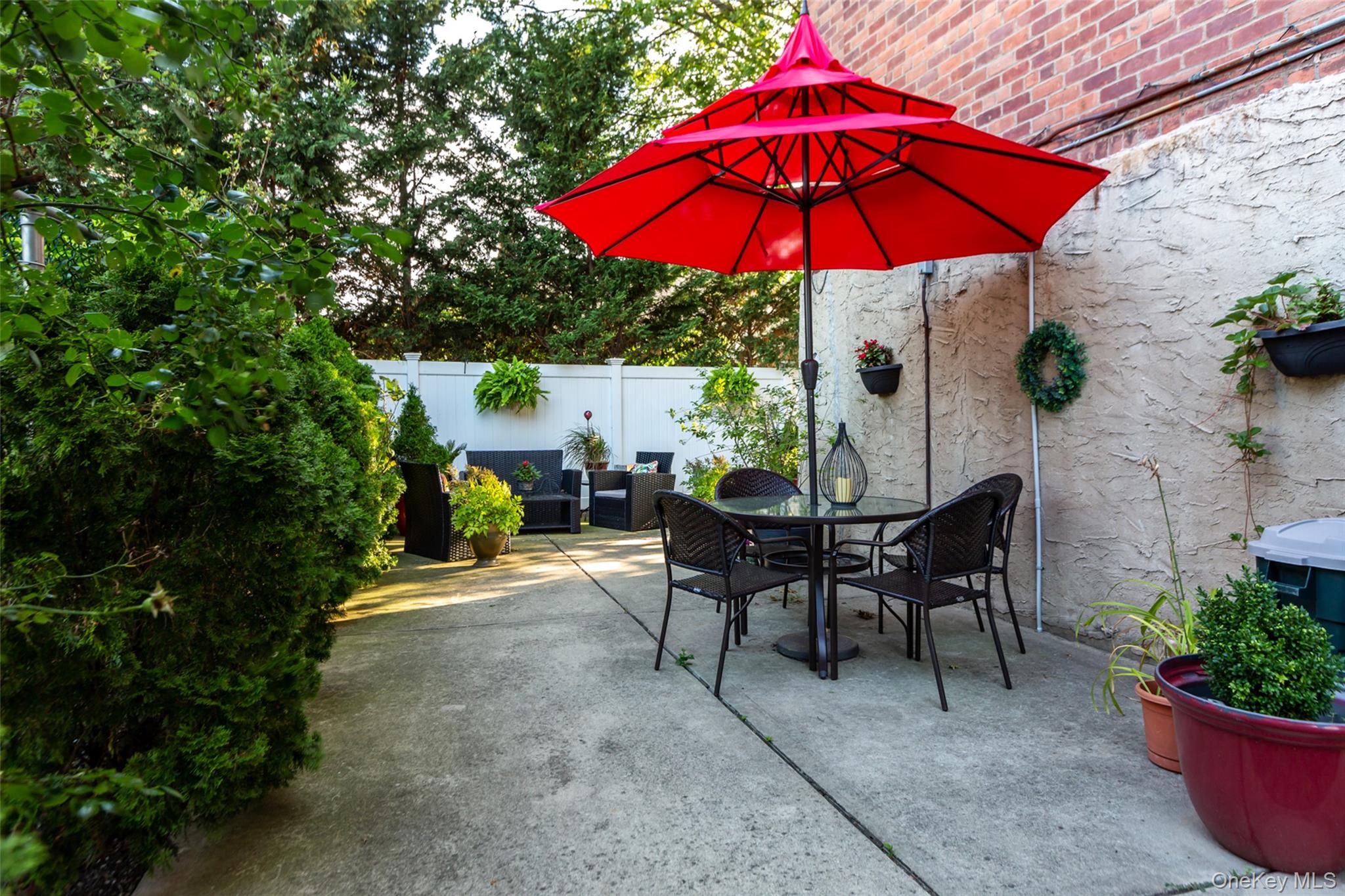 504 Merrick Road, Unit 2K Lynbrook, NY 11563 - Photo 18 of 20 a view of a backyard with sitting area and furniture