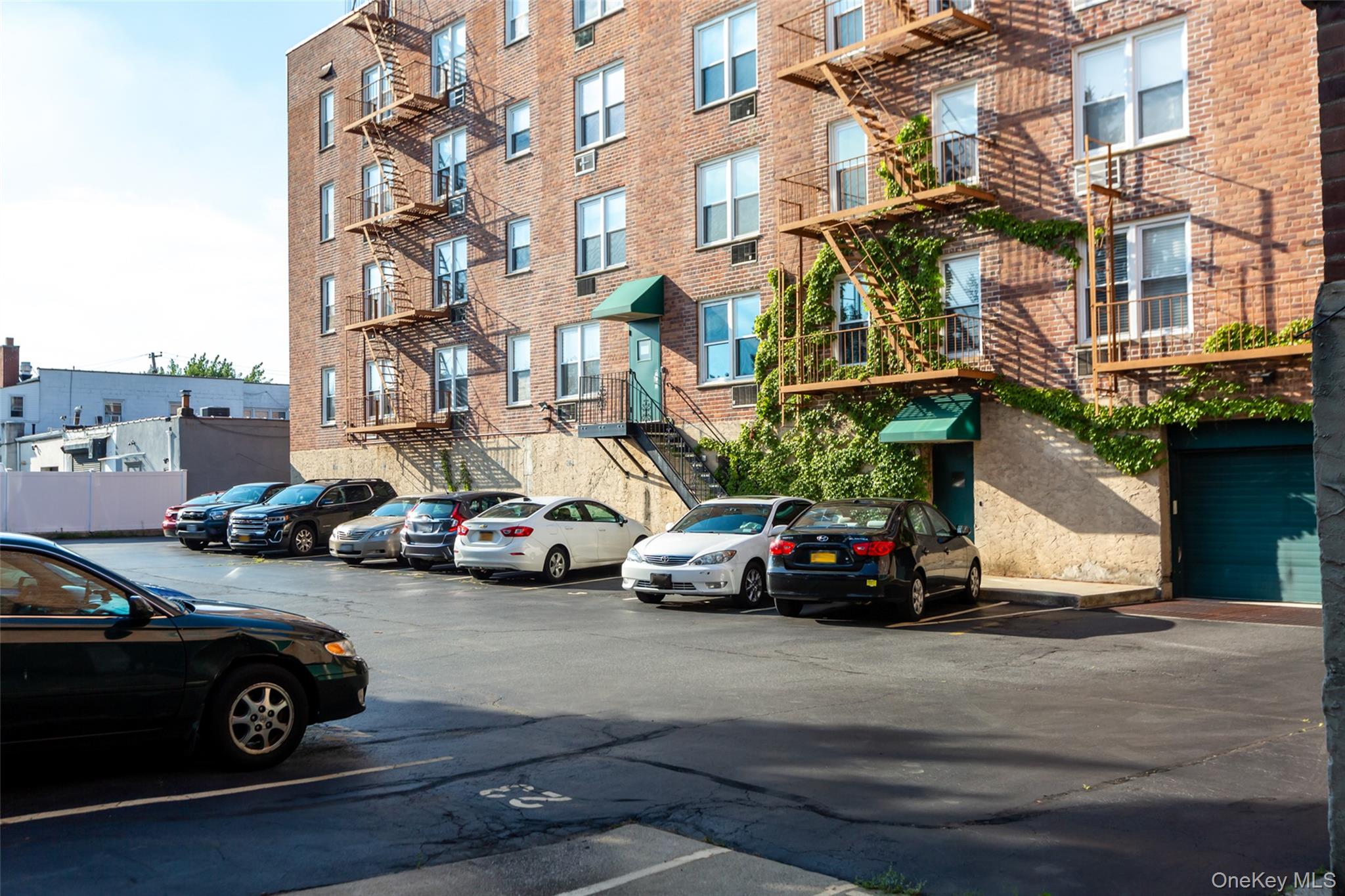 504 Merrick Road, Unit 2K Lynbrook, NY 11563 - Photo 20 of 20 two cars parked in front of a house