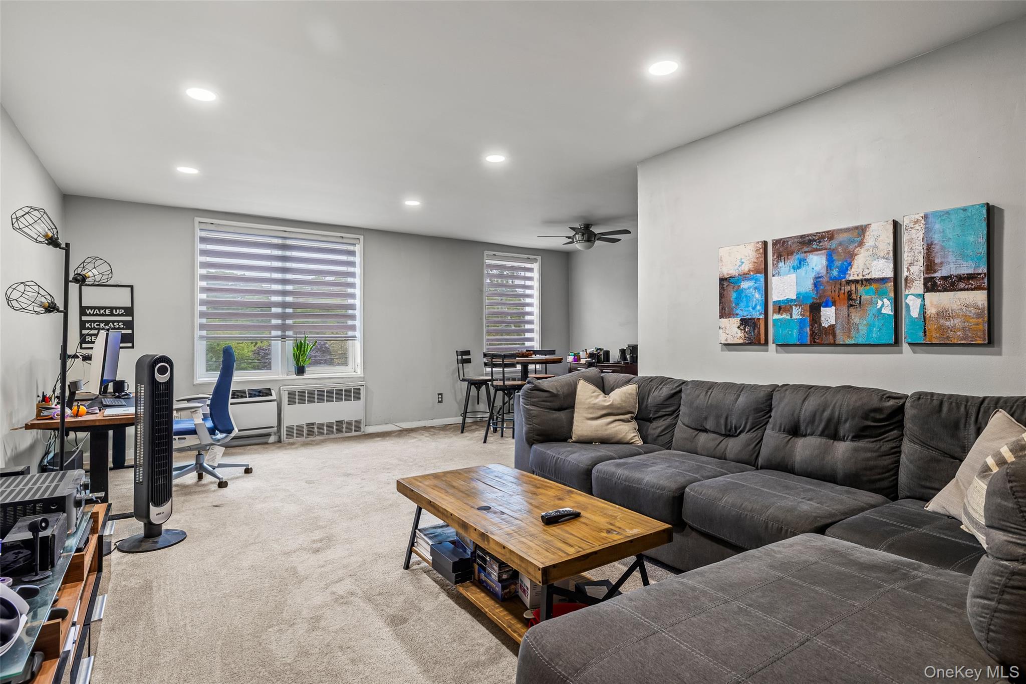 504 Merrick Road, Unit 2K Lynbrook, NY 11563 - Photo 4 of 20 a living room with furniture a table and a flat screen tv