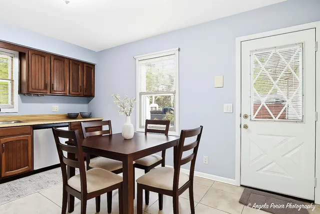 a view of a dining room with furniture and a window