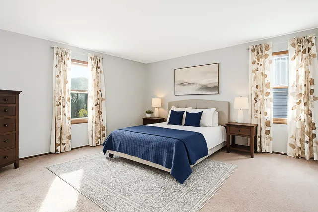 a spacious bedroom with a bed and a window