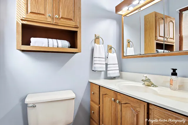 a bathroom with a sink a toilet and a mirror