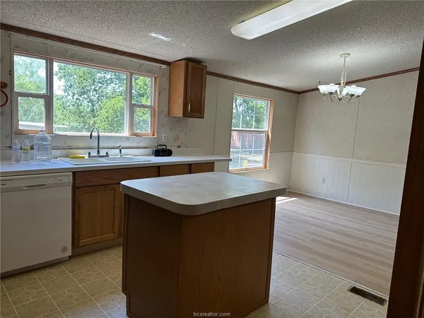 a kitchen with stainless steel appliances a stove refrigerator sink and microwave