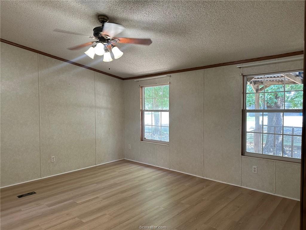 3180 Henderson Road Millican, TX 77868 - Photo 5 of 10 wooden floor in an empty room with a window