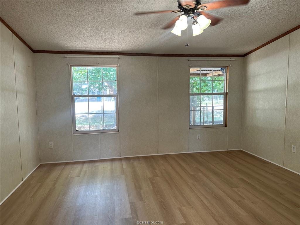 3180 Henderson Road Millican, TX 77868 - Photo 6 of 10 wooden floor in an empty room with a window