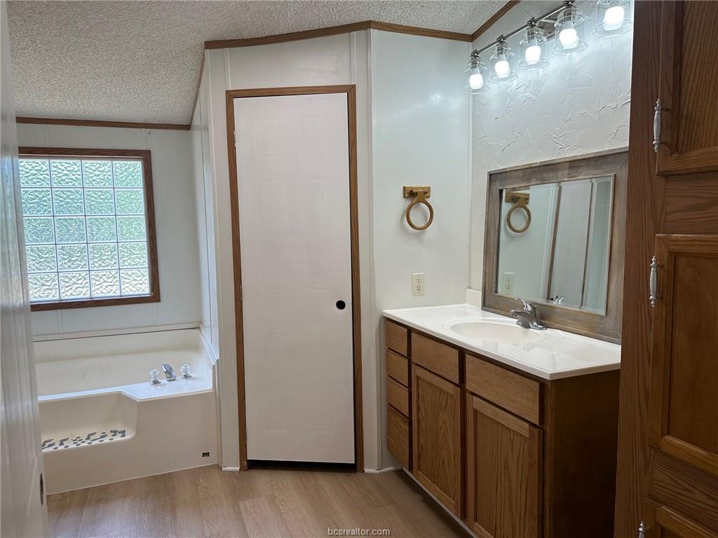 3180 Henderson Road Millican, TX 77868 - Photo 7 of 10 a bathroom with a sink and a mirror