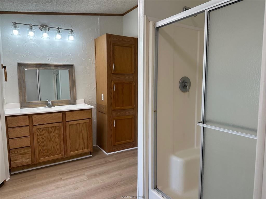 3180 Henderson Road Millican, TX 77868 - Photo 8 of 10 a bathroom with a double vanity sink and mirror
