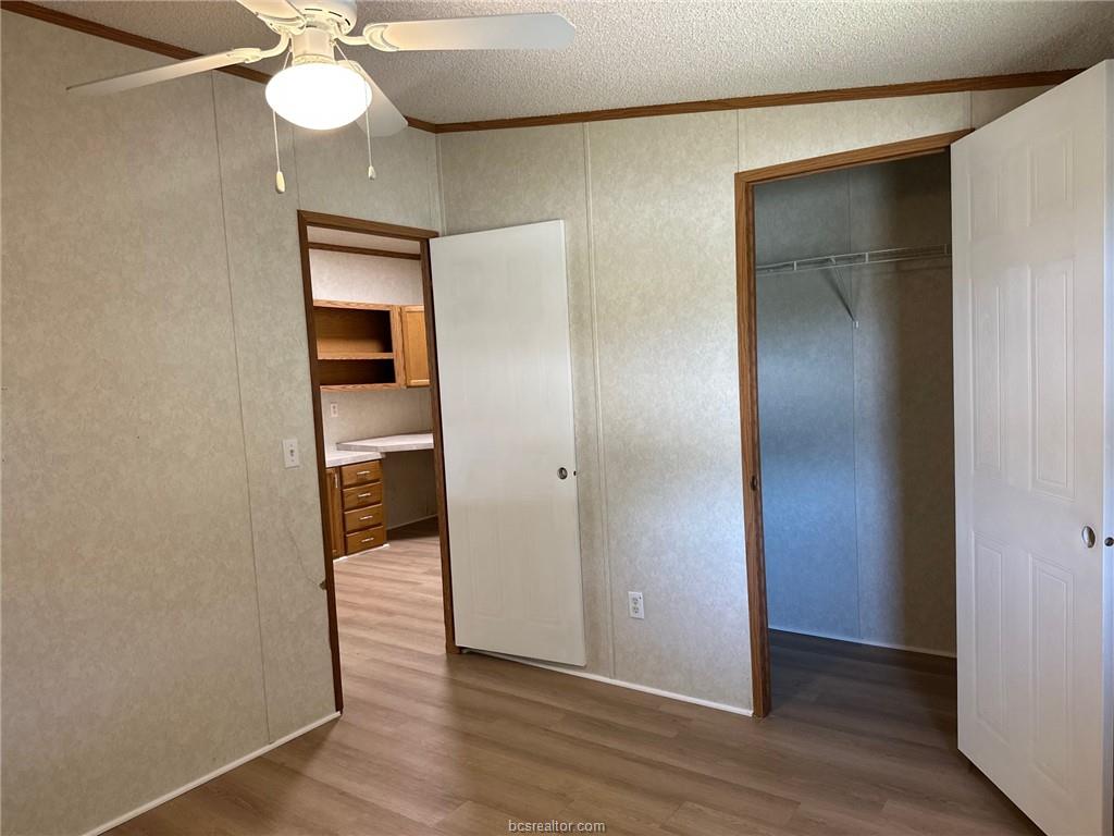 3180 Henderson Road Millican, TX 77868 - Photo 10 of 10 a view of a room with wooden floor closet and a bathroom