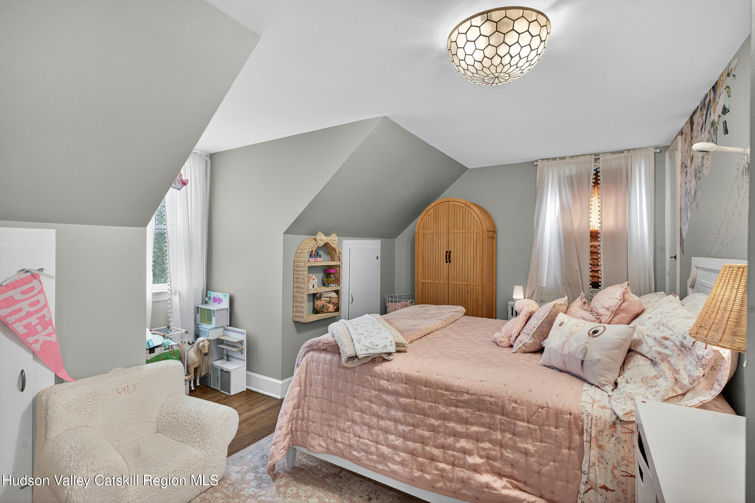 41 New Paltz Road Highland, NY 12528 - Photo 21 of 42 a bedroom with a bed and a chandelier