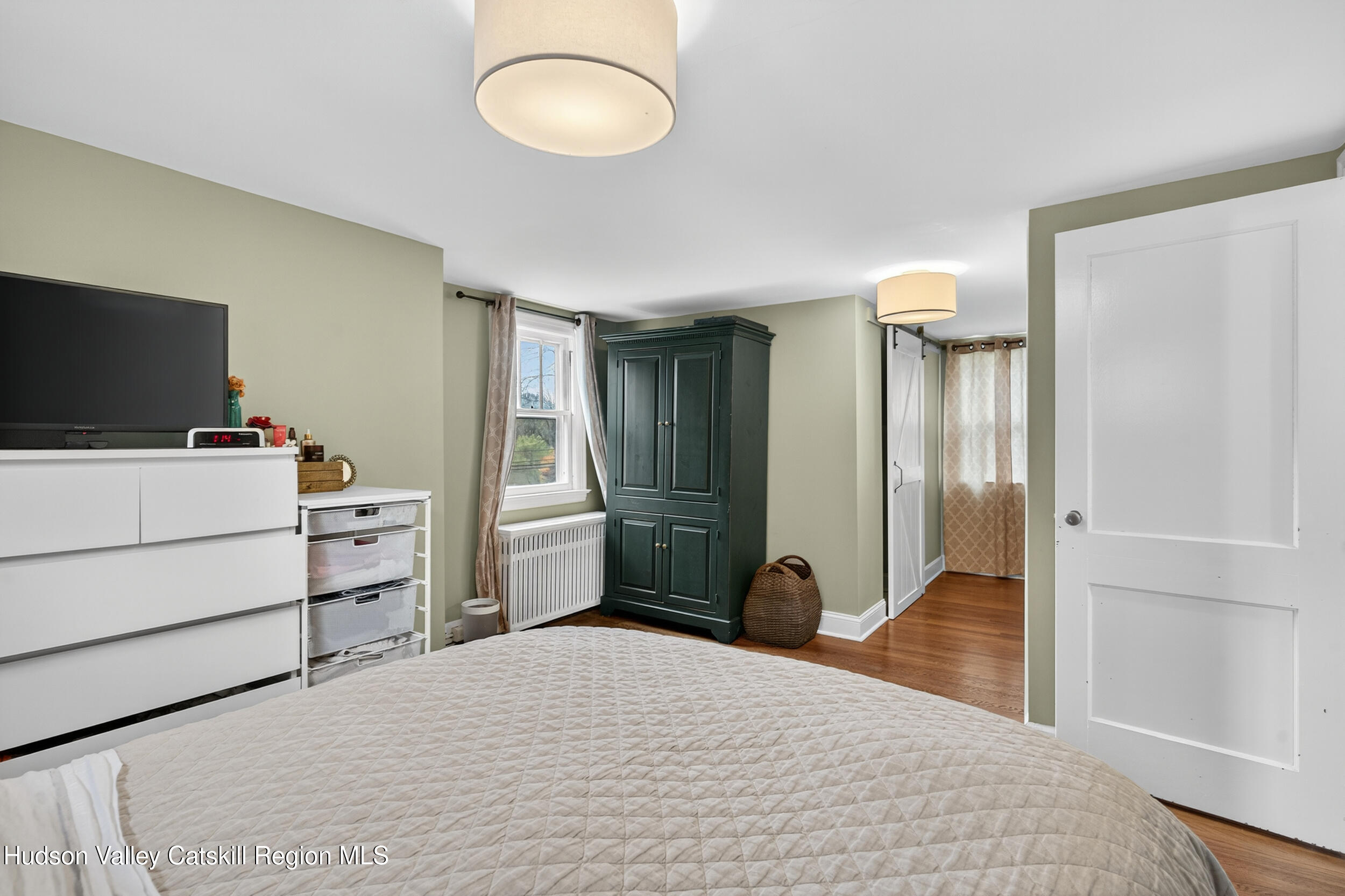 41 New Paltz Road Highland, NY 12528 - Photo 28 of 42 a bedroom with a bed and a flat screen tv