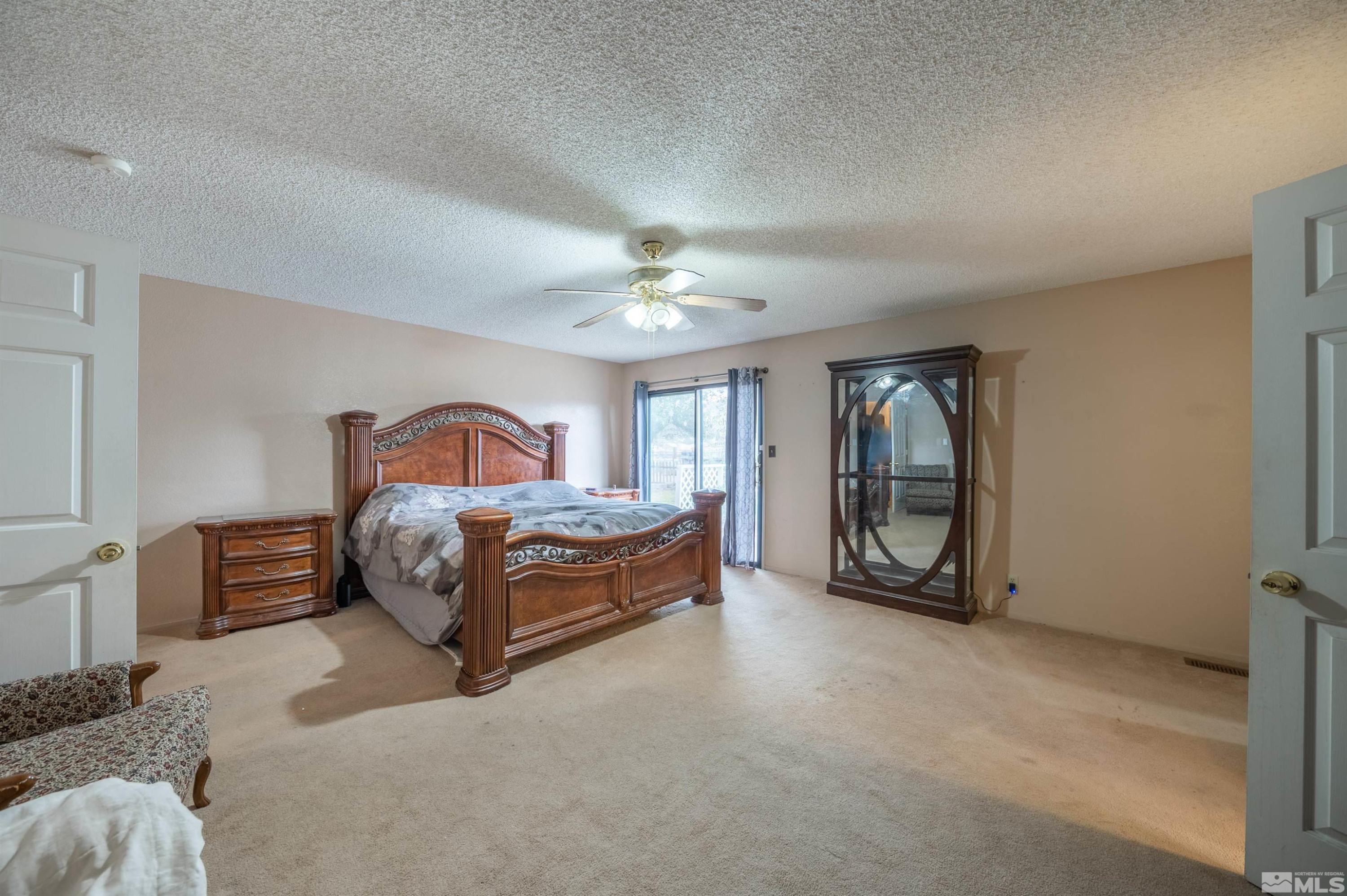 10880 Deodar Way Reno, NV 89506 - Photo 11 of 38 a bedroom with a bed lamp and dresser