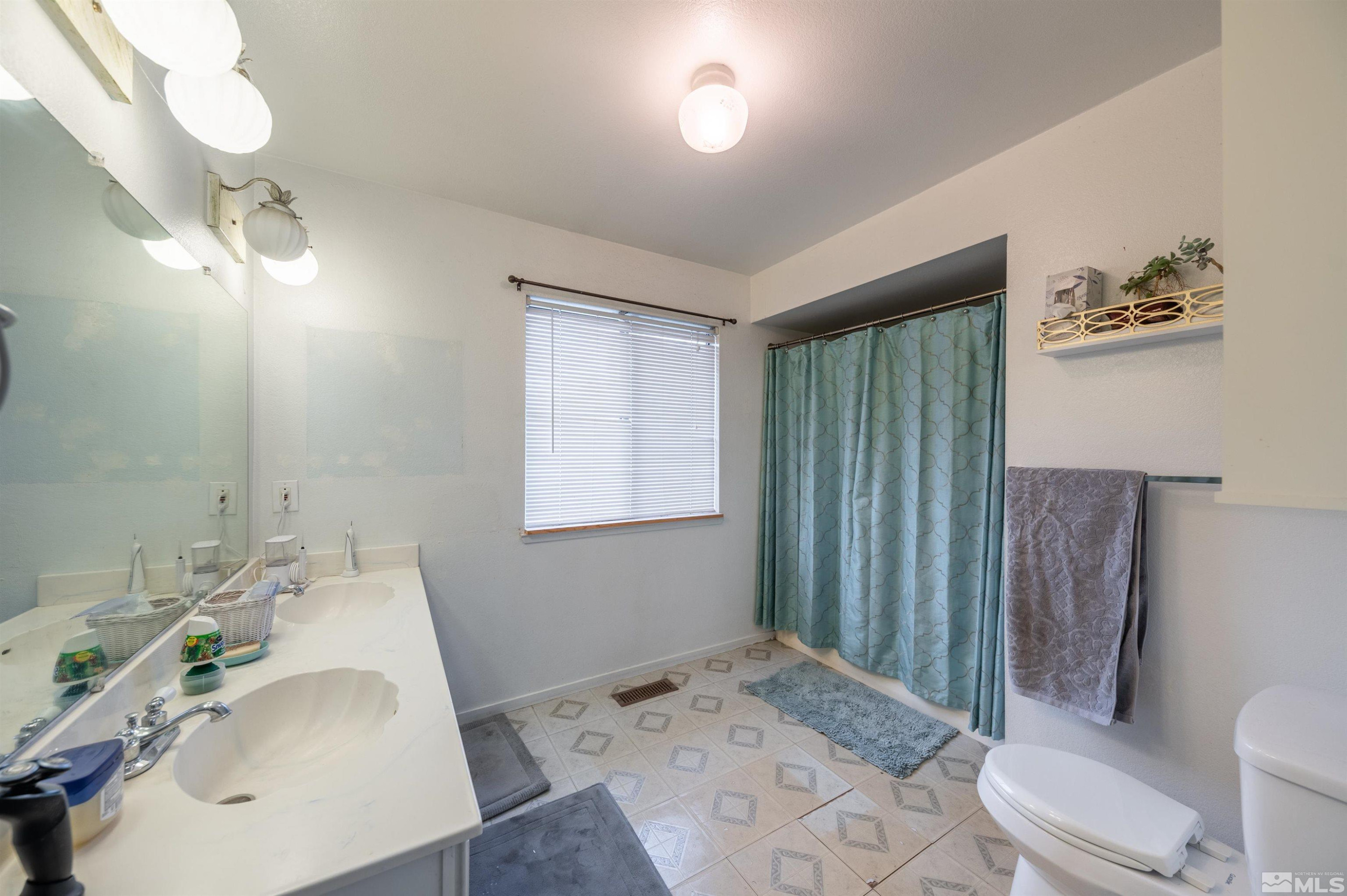 10880 Deodar Way Reno, NV 89506 - Photo 12 of 38 a bathroom with a sink toilet and shower