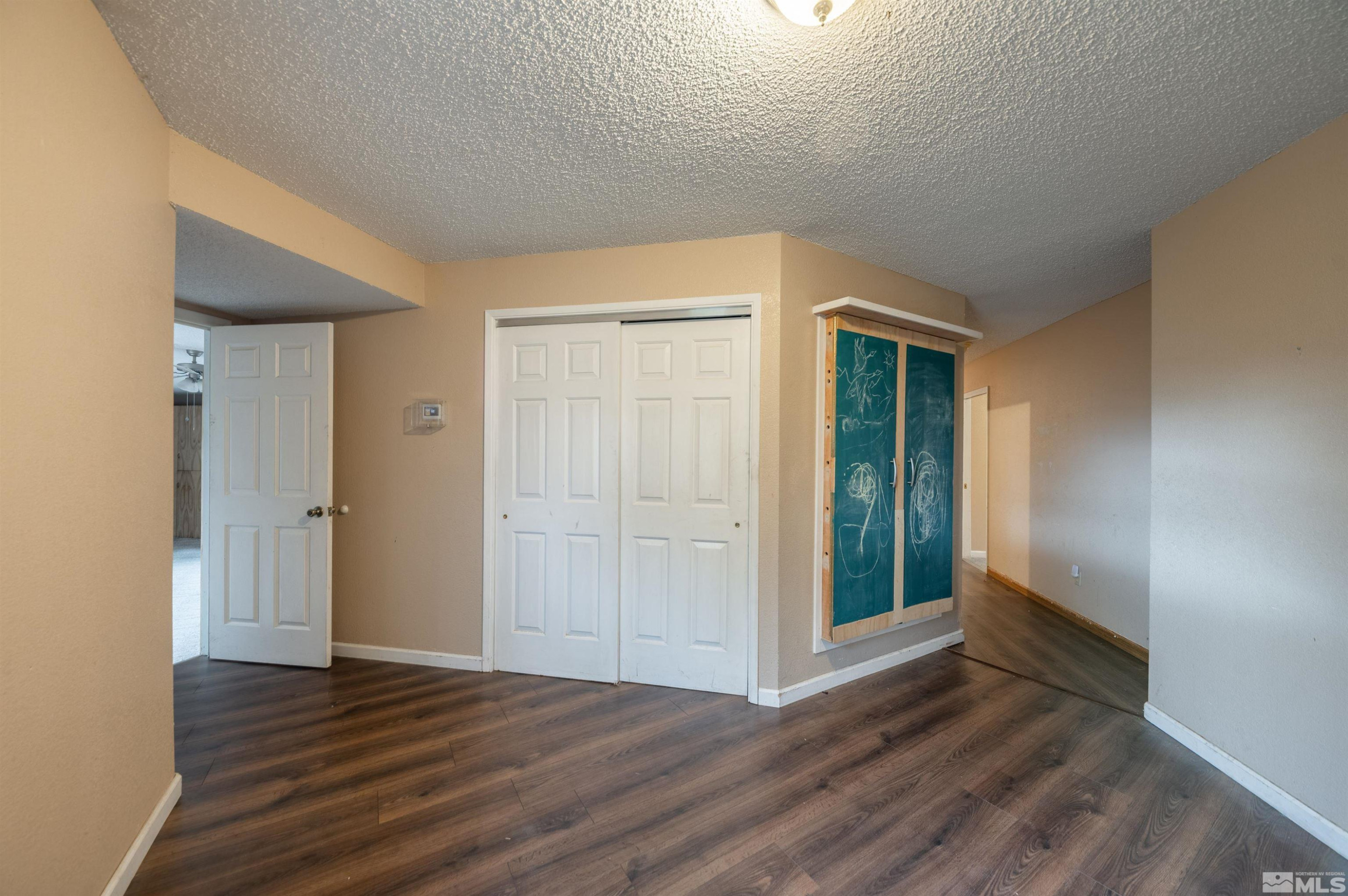 10880 Deodar Way Reno, NV 89506 - Photo 21 of 38 wooden floor in an empty room with a window