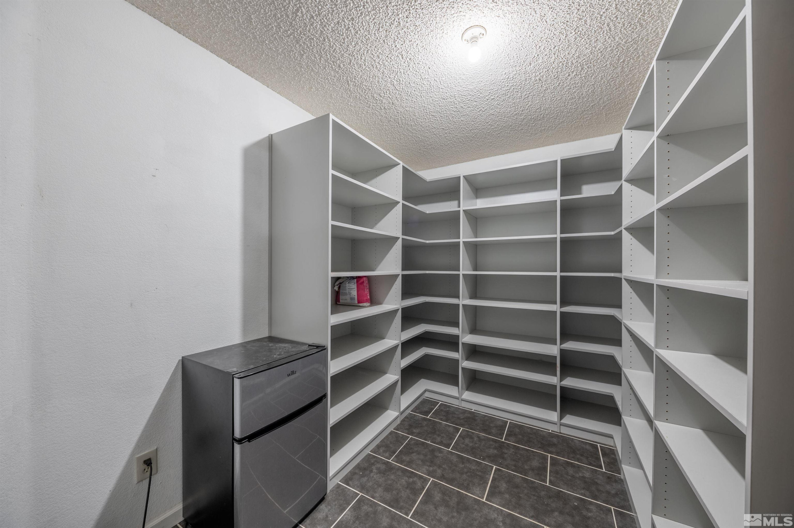 10880 Deodar Way Reno, NV 89506 - Photo 22 of 38 a view of walk in closet with empty racks
