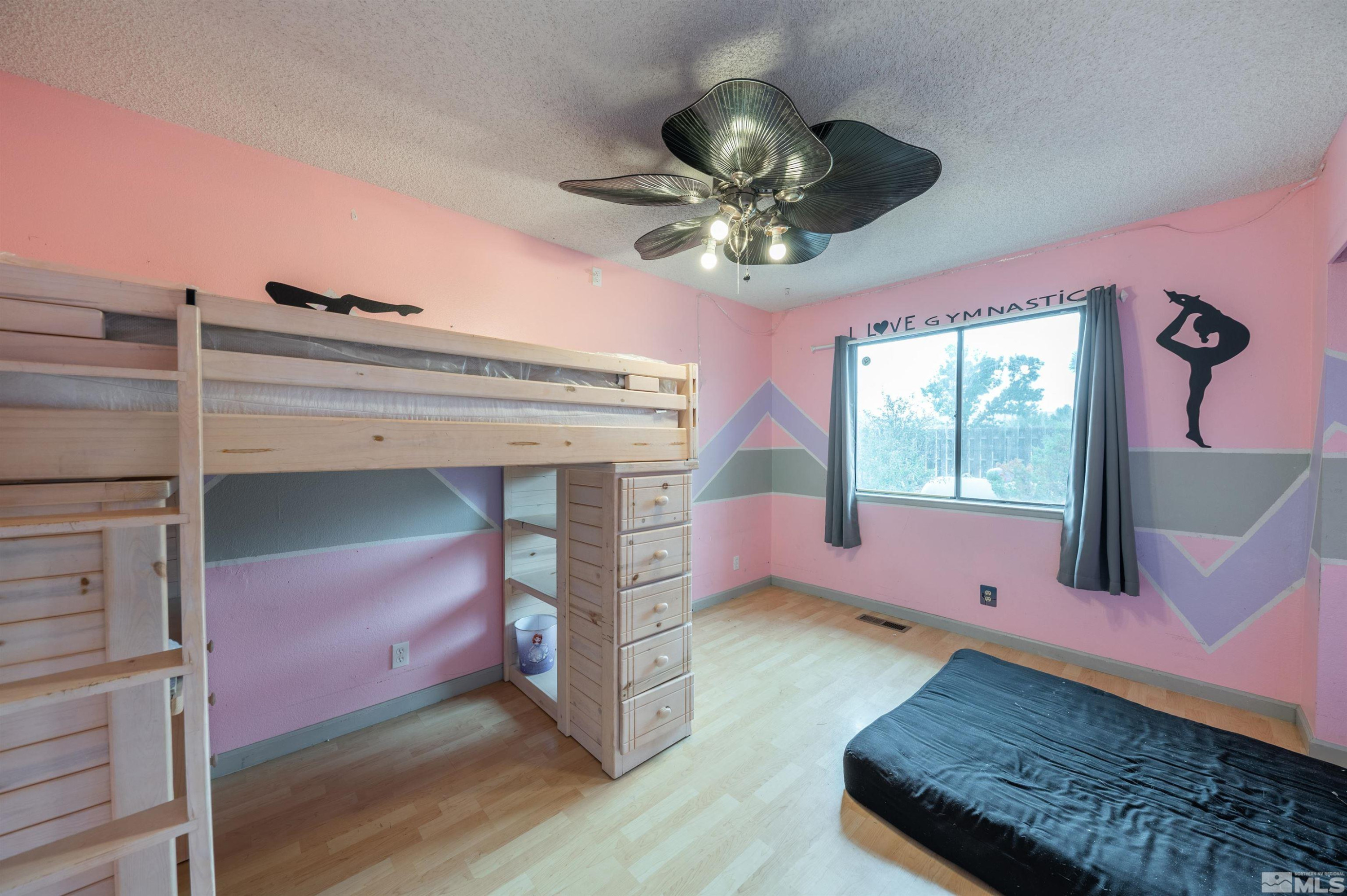 10880 Deodar Way Reno, NV 89506 - Photo 27 of 38 a living room with furniture and a chandelier