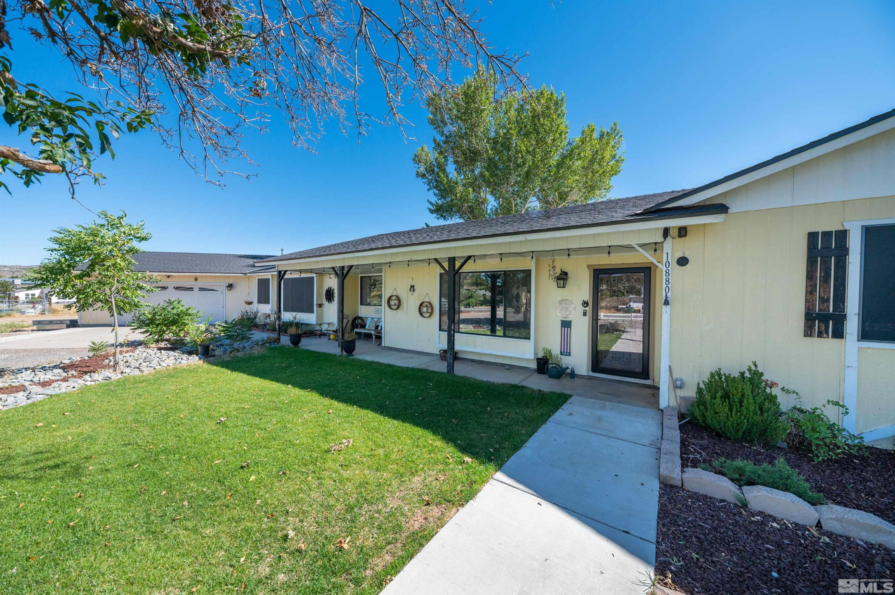 10880 Deodar Way Reno, NV 89506 - Photo 3 of 38 a front view of a house with a yard and porch