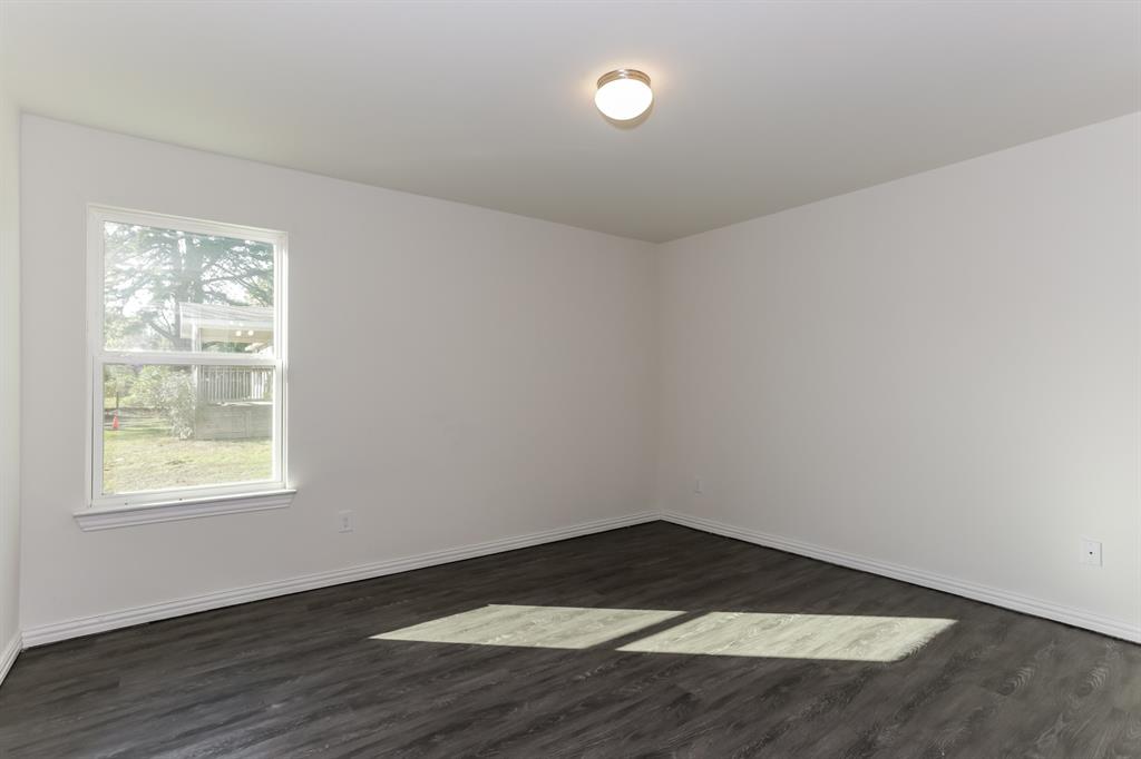 408 Jonathan Street Athens, TX 75751 - Photo 13 of 21 an empty room with wooden floor and windows