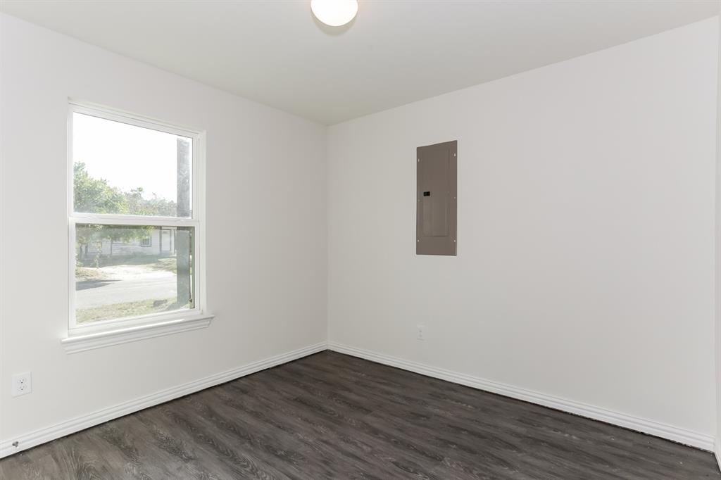 408 Jonathan Street Athens, TX 75751 - Photo 14 of 21 an empty room with wooden floor and windows