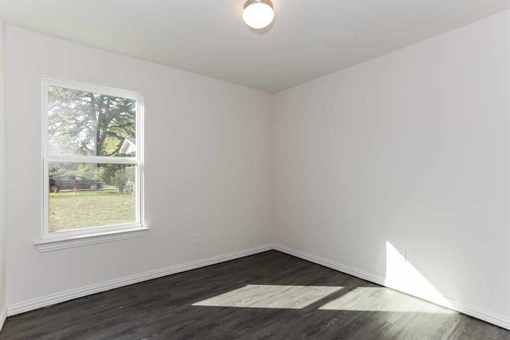 408 Jonathan Street Athens, TX 75751 - Photo 16 of 21 an empty room with wooden floor and windows