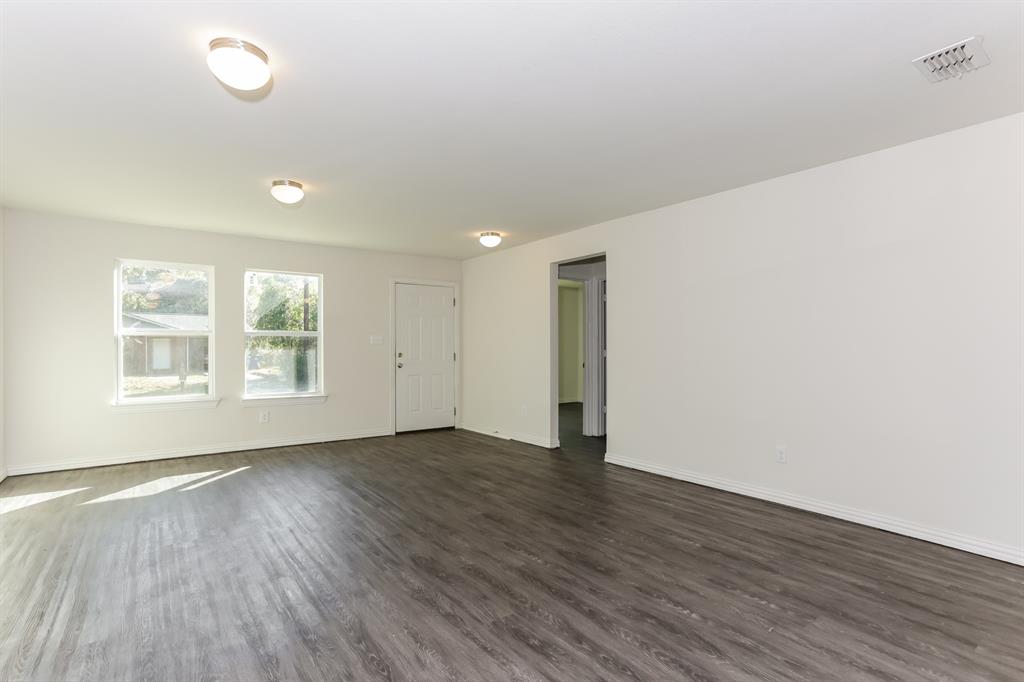 408 Jonathan Street Athens, TX 75751 - Photo 2 of 21 an empty room with wooden floor and windows