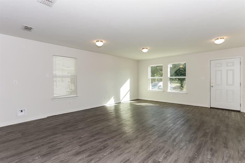408 Jonathan Street Athens, TX 75751 - Photo 3 of 21 an empty room with wooden floor and windows