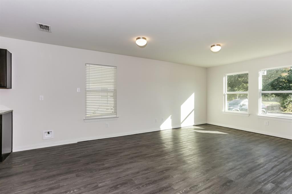 408 Jonathan Street Athens, TX 75751 - Photo 4 of 21 an empty room with wooden floor and windows