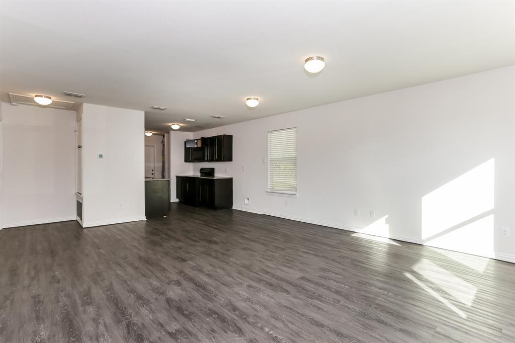 408 Jonathan Street Athens, TX 75751 - Photo 5 of 21 a view of empty room with wooden floor and kitchen