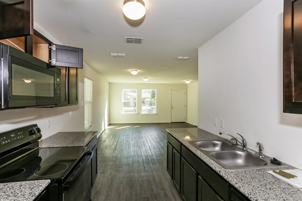 408 Jonathan Street Athens, TX 75751 - Photo 9 of 21 a kitchen with sink stove and cabinets