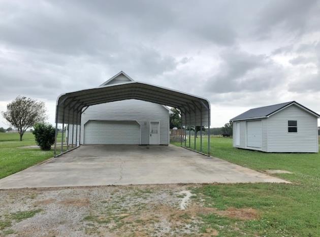 4074 Shady Grove Road Morrison, TN 37357 - Photo 2 of 29 a front view of a house with a yard and garage