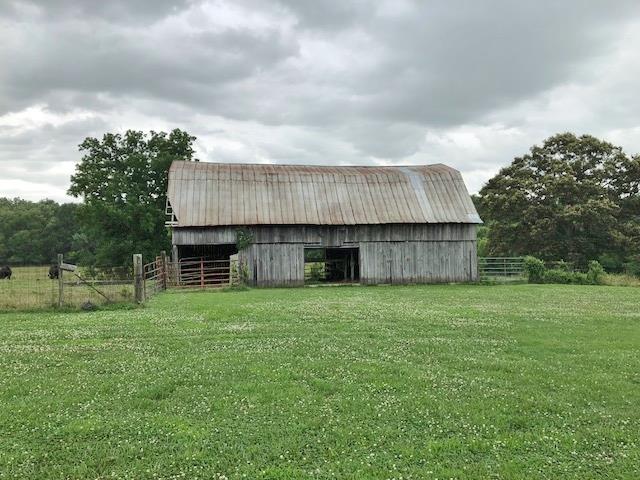 4074 Shady Grove Road Morrison, TN 37357 - Photo 3 of 29 a view of a backyard with barn and a large tree