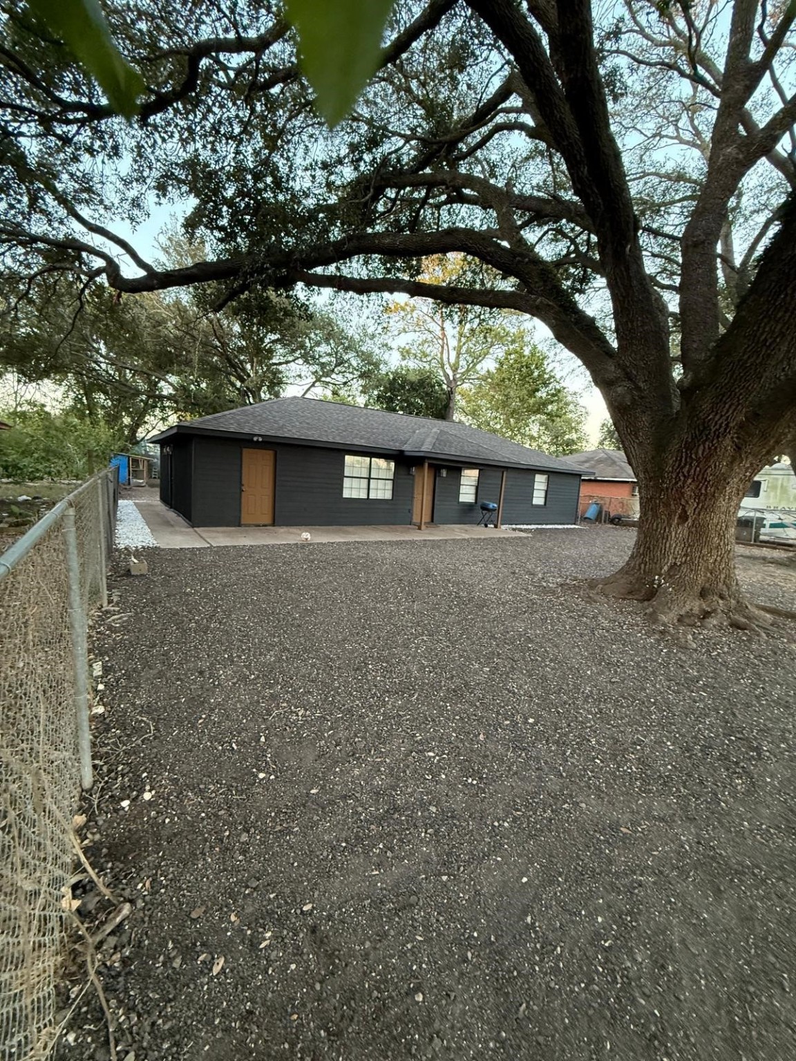 a view of house with a large tree