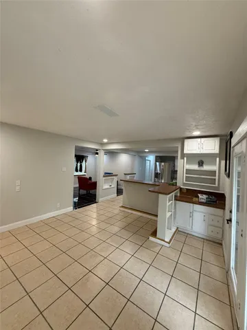 a kitchen with kitchen island a stove a counter top space and cabinets