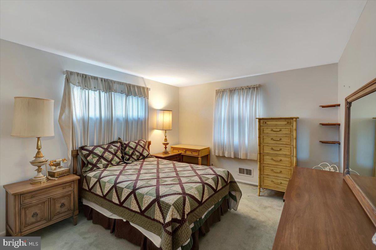 3854 Terka Circle Randallstown, MD 21133 - Photo 12 of 19 a bedroom with a bed and a dresser