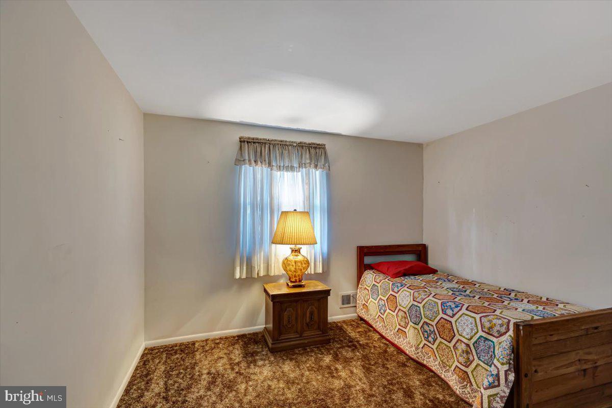 3854 Terka Circle Randallstown, MD 21133 - Photo 13 of 19 a bed sitting in a bedroom next to a window