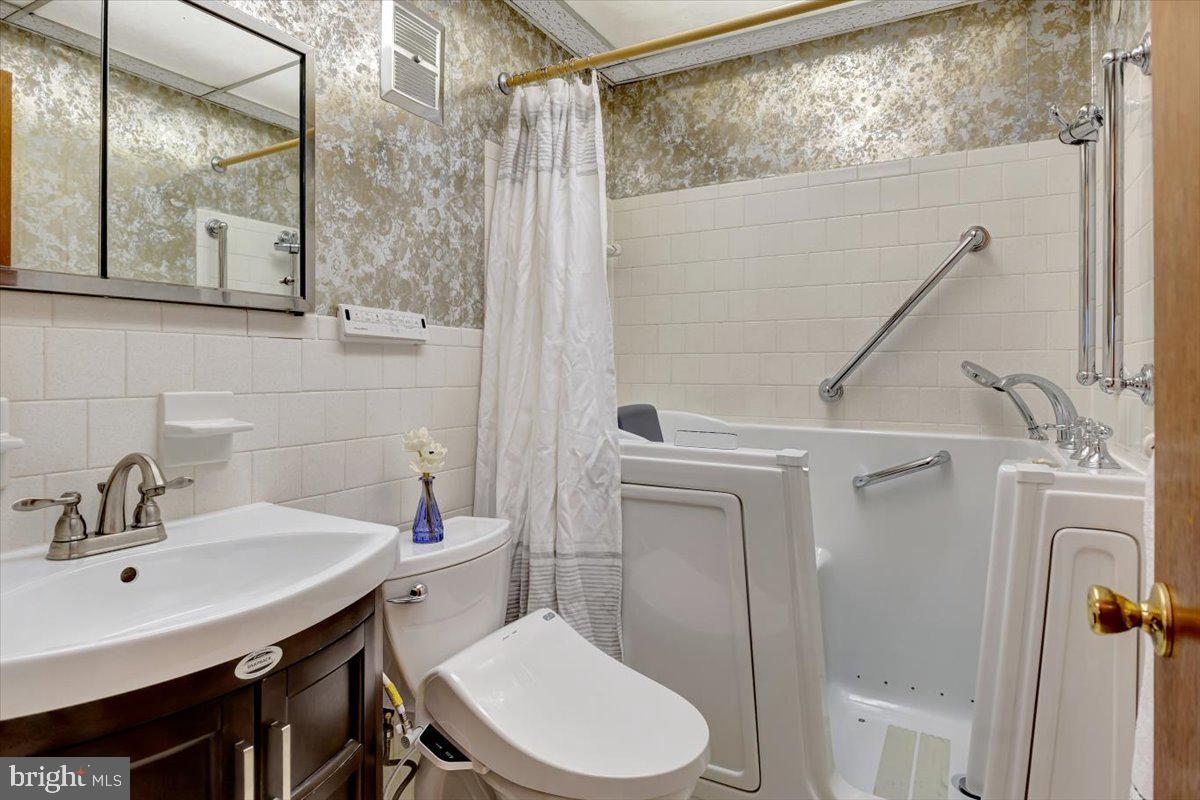 3854 Terka Circle Randallstown, MD 21133 - Photo 14 of 19 a bathroom with a sink a toilet and shower