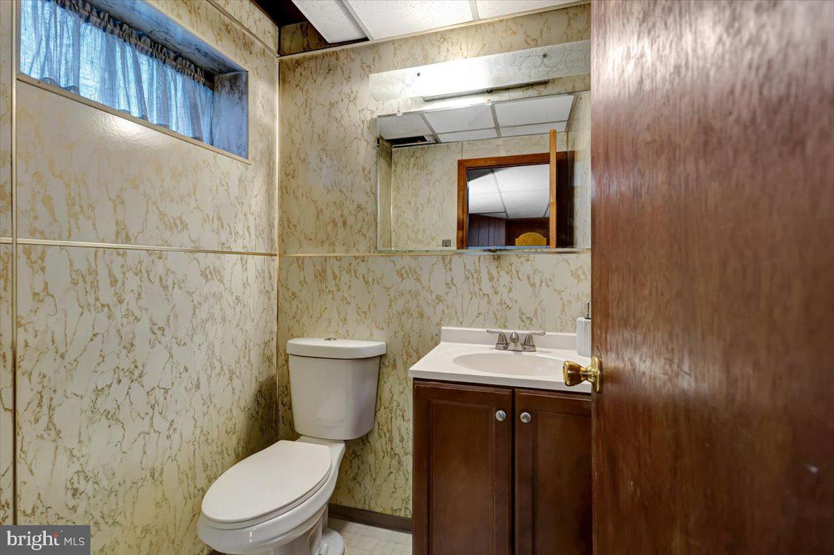 3854 Terka Circle Randallstown, MD 21133 - Photo 19 of 19 a bathroom with a toilet a sink and mirror