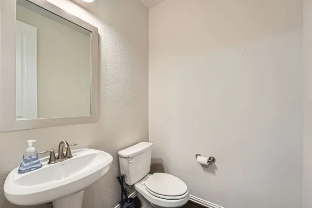 a white toilet sitting next to a white sink