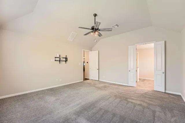 a view of a room with a ceiling fan