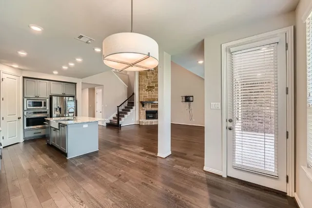 a room with lots of wooden furniture and a chandelier