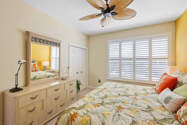a spacious bedroom with a bed and a chandelier