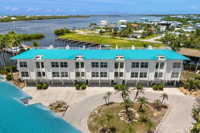 a view of a house with swimming pool and furniture