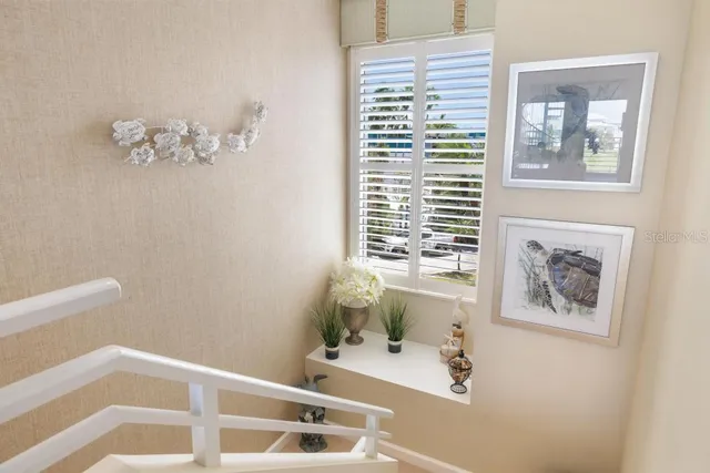 a living room with furniture kitchen view and a chandelier