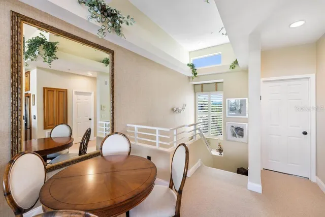 a living room with stainless steel appliances kitchen island granite countertop furniture and a flat screen tv