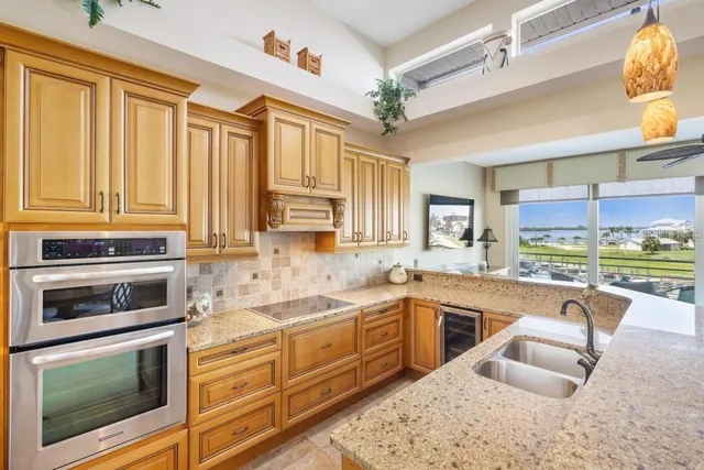 a living room with furniture a chandelier and a dining table