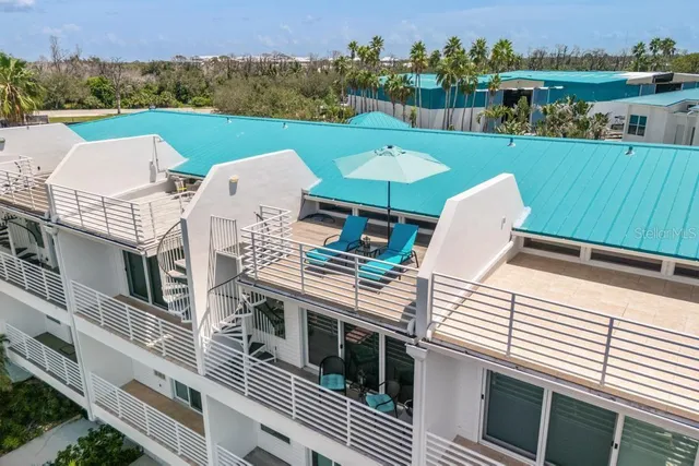 a view of a patio with table and chairs with wooden floor and fence