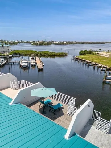 a view of a house with a swimming pool and sitting area