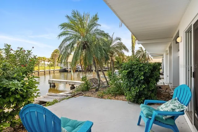 a swimming pool with outdoor seating and a lake view