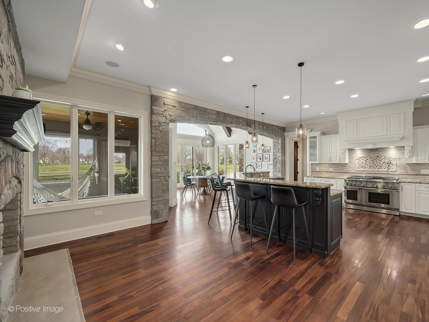 1129 Summit Hills Lane Naperville, IL 60563 - Photo 13 of 72 a dining room with stainless steel appliances furniture large window and wooden floor