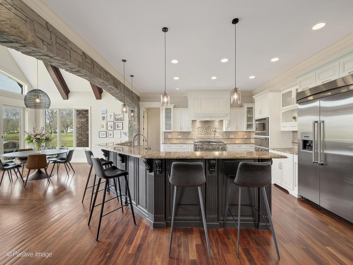 1129 Summit Hills Lane Naperville, IL 60563 - Photo 15 of 72 a large kitchen with a table and chairs