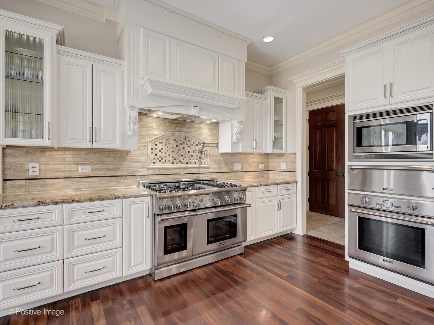 1129 Summit Hills Lane Naperville, IL 60563 - Photo 16 of 72 a kitchen with granite countertop white cabinets and stainless steel appliances